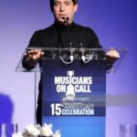 Man speaking at a podium at a Musicians On Call celebration