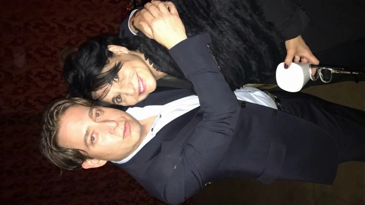Two men embracing playfully at a party