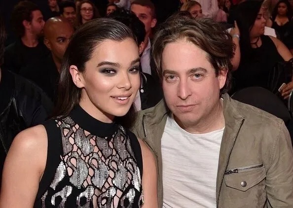 Man and woman posing together at a crowded event
