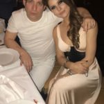 Man and woman in white seated at a dinner table