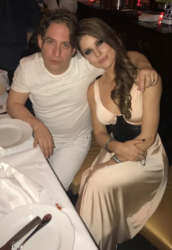 Man and woman in white seated at a dinner table