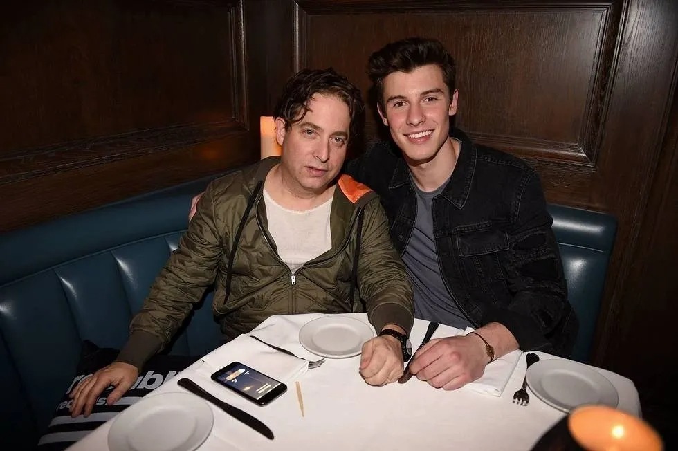 Two men sitting in a restaurant booth