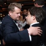 Two men greeting each other with a hug at a party