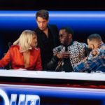 Judges leaning together in discussion at The Four desk