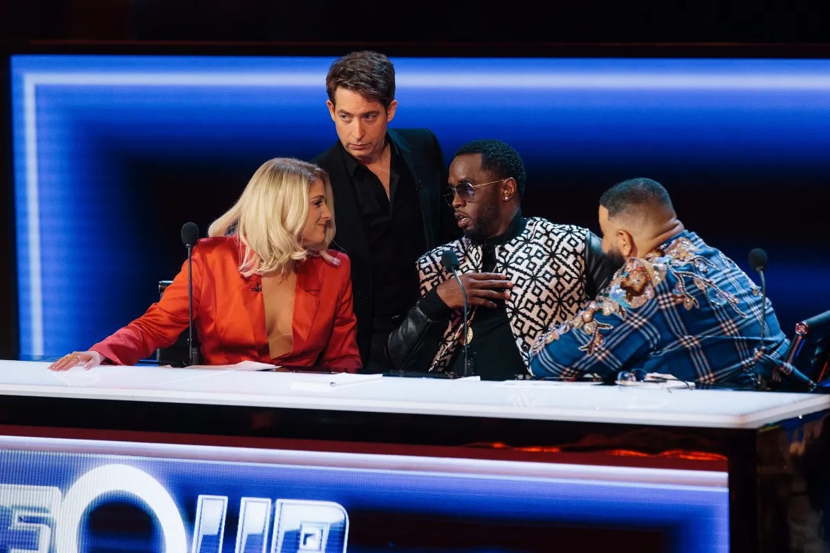 Judges leaning together in discussion at The Four desk