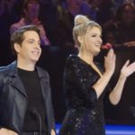 Man and woman standing on stage before an audience