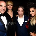 Two men posing with two women at a formal event