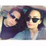 Man and woman in sunglasses taking a car selfie