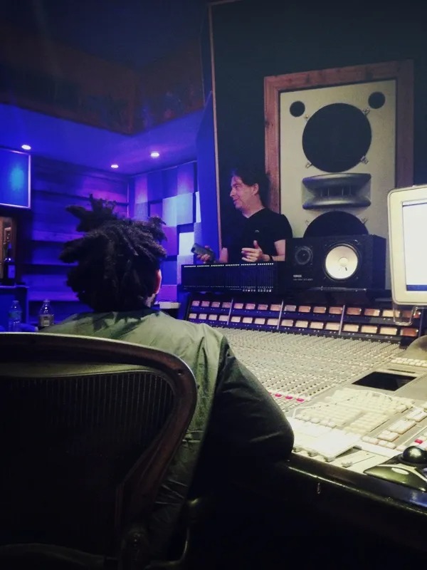 Recording studio with mixing board and large monitors