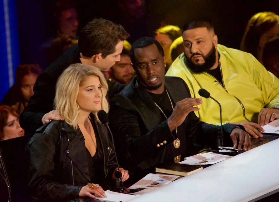 Panel of judges reading notes at a desk