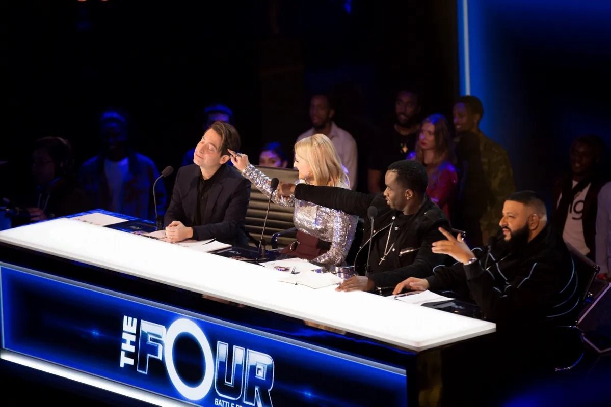 Judges talking across The Four desk during a taping