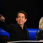 Judge pointing out toward the audience from the desk