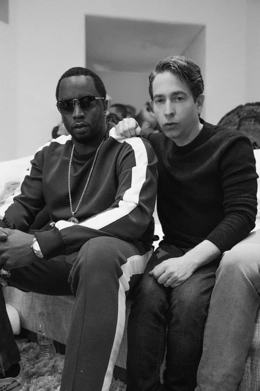 Black and white photo of two men seated side by side