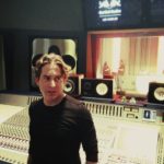 Man posing at a studio mixing console