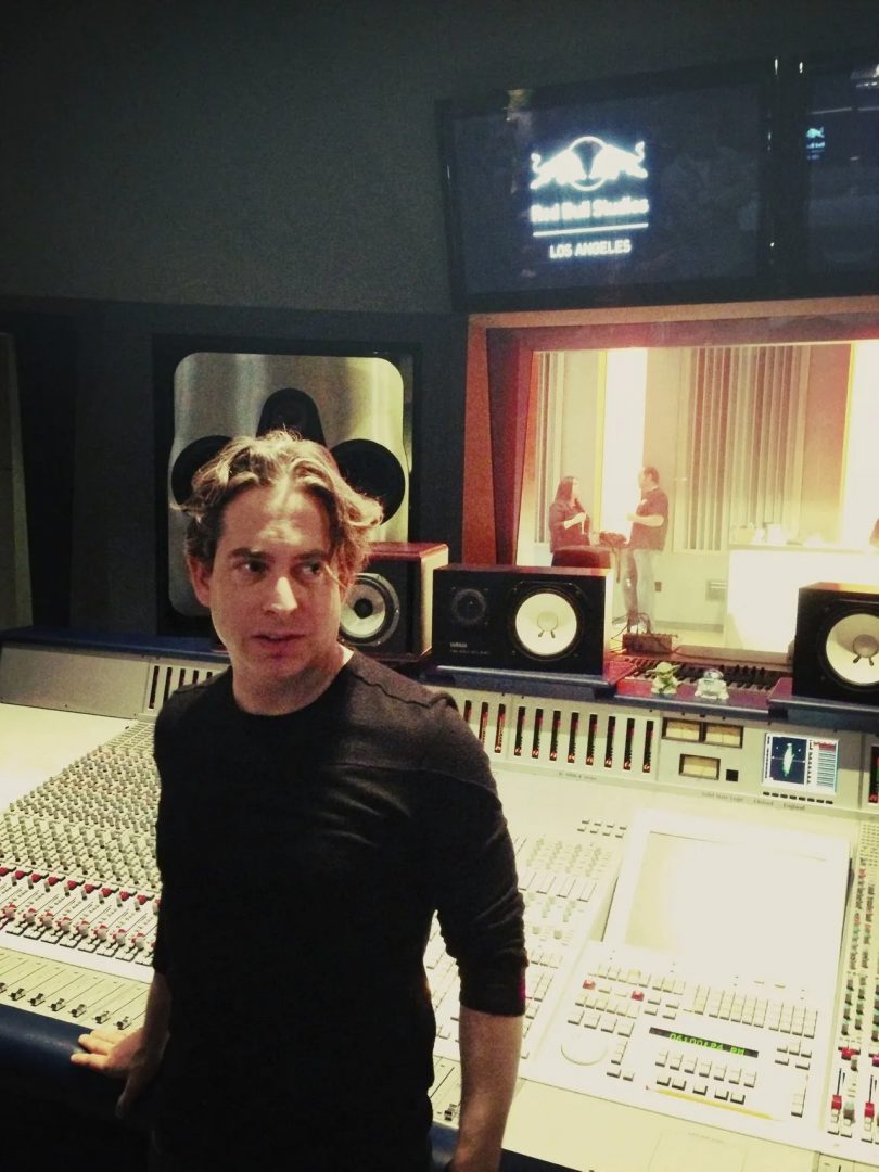Man posing at a studio mixing console