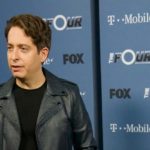 Man in a leather jacket at a Fox and T-Mobile press wall