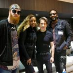 Group of four posing together in a green room