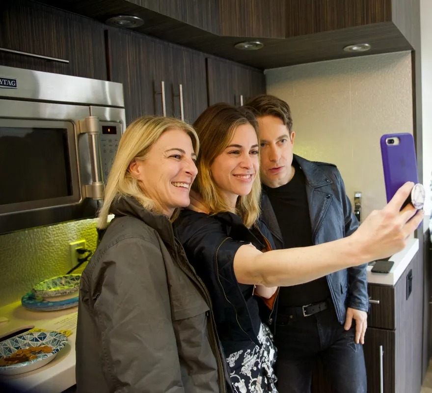 Three women taking a selfie in a backstage kitchen
