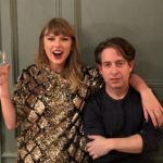 Woman in a sequin dress raising a glass beside a man