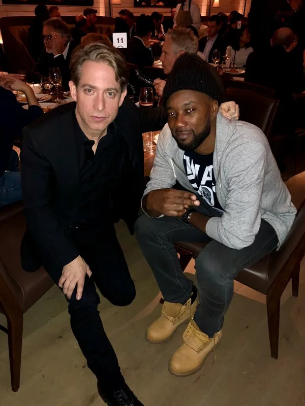 Two men posing together at a banquet table