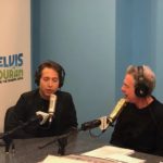 Radio host and guest talking into studio microphones