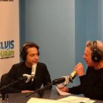 Guest speaking into a microphone during a radio interview