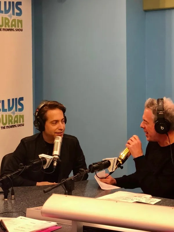 Guest speaking into a microphone during a radio interview