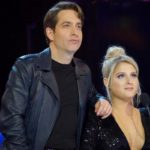 Man and woman leaning together at a judges desk