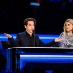 Two judges talking at a blue-lit desk