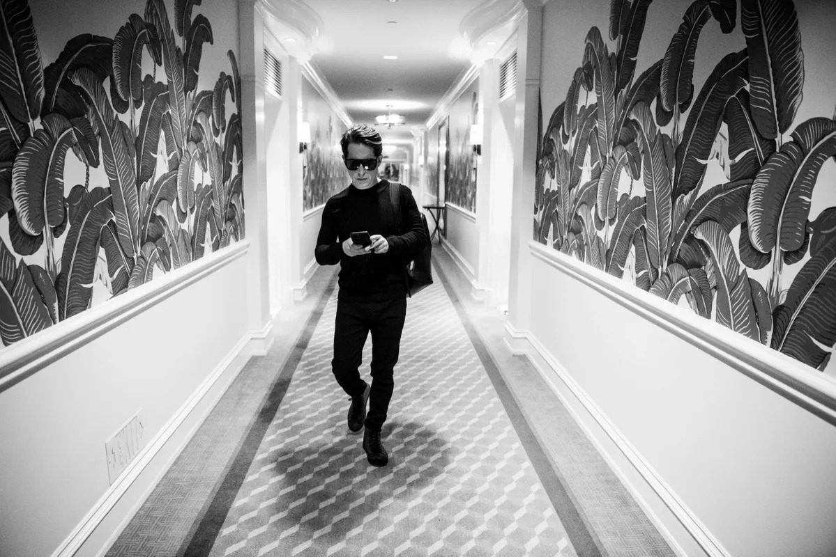 Man walking down a hallway with graffiti-style walls