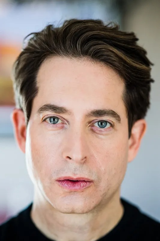 Close-up portrait of a man with dark hair