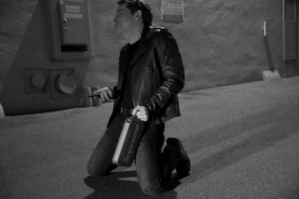 Black and white photo of a man kneeling in a hallway