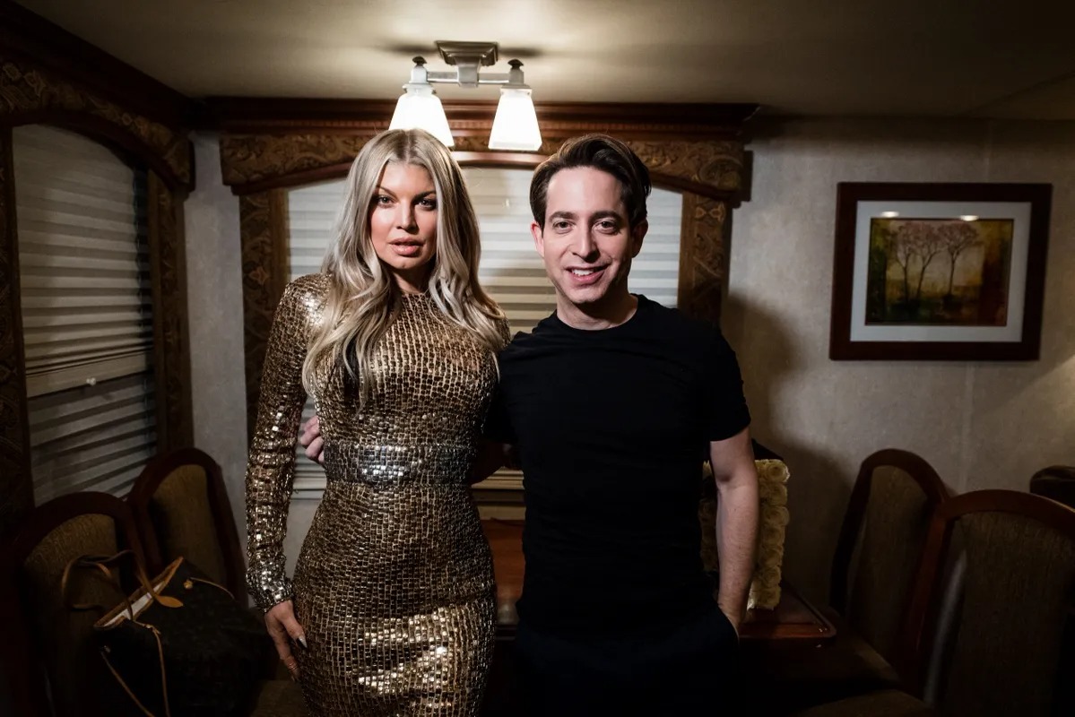 Man and woman in a sequin dress posing in a trailer