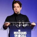 Speaker at a clear podium at a Musicians On Call event