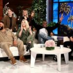 Guests waving from the couches of a television talk show set